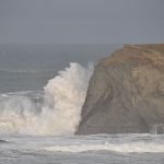 Surf breaking on rock