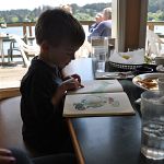 Ben, reading full sentences for the very first time, in Traveler's Cove restaurant in Florence